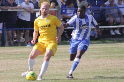 Canvey's Levett on-the-ball with Bridge's Okunja [Image Credit: Andy W]